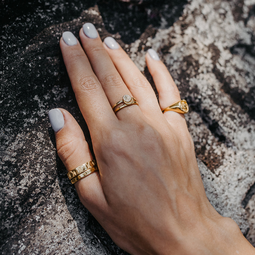 Silver and gold store rings on same hand